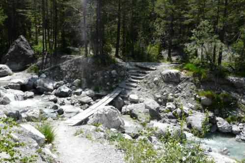 Traversée d'une passerelle symbolique dès le départ sur le torrent qui descend du vallon des Ascles